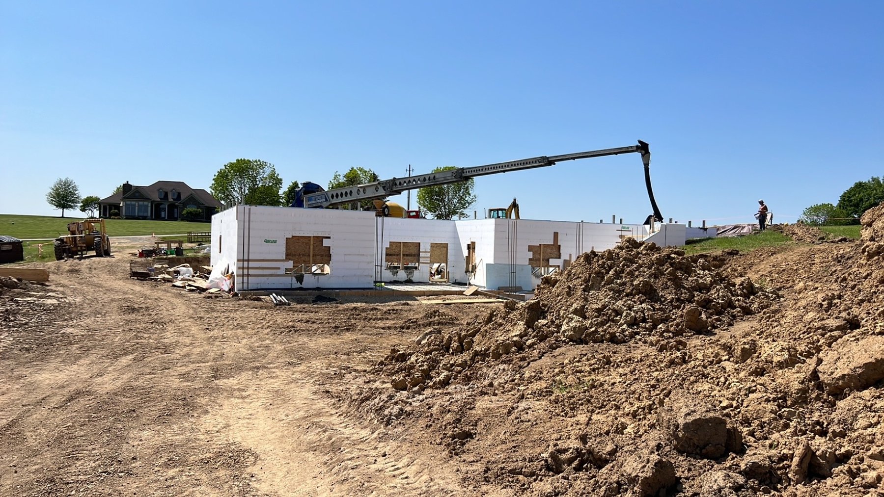 Concrete pump truck placing concrete into ICF walls